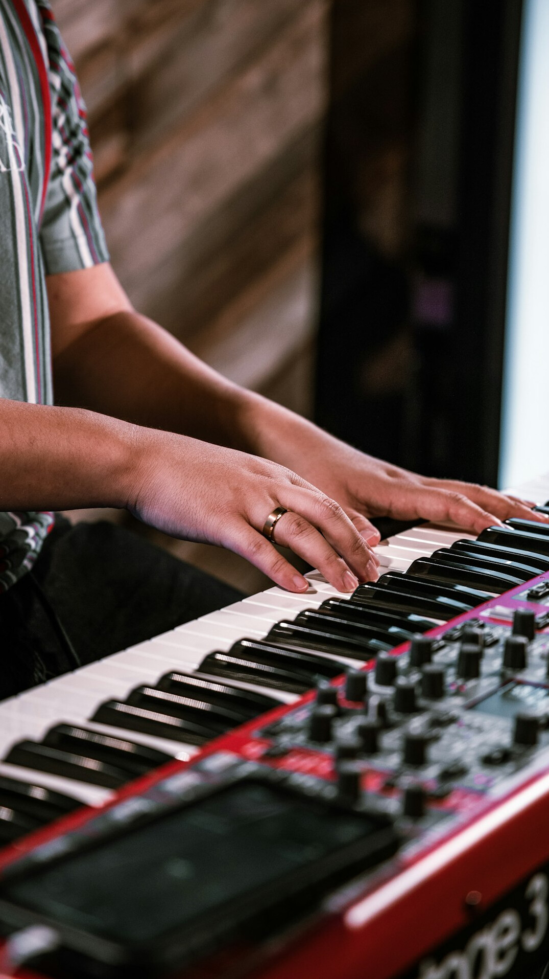 Close up of hands typing on a laptop keyboard in an office